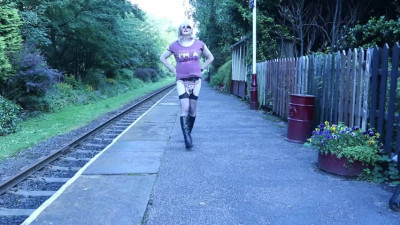 Crossdressed ooudoors on a public railway platform