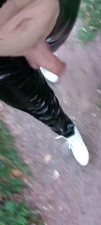 Exhibition outdoor in public woods in vinyl catsuit and white heel in front of stranger