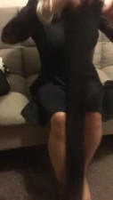 Crossdresser putting on stockings and heels