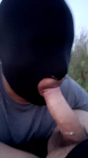 Masked slave sucking cock