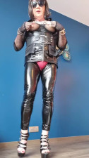 Teasing crossdresser in PVC leggings