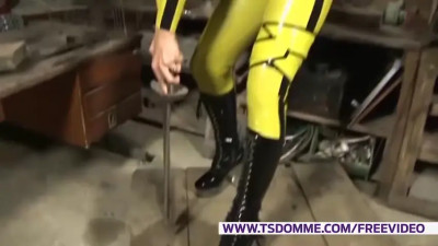Redhead shemale in yellow latex outfit jerks off her small cock