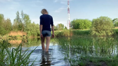 Transgirl Alexa Cosmic soaking and swimming in denim shorts and top and nude in the lake