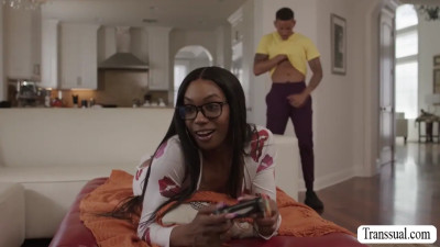 Bad brunette fucks Ebonys ass while playing