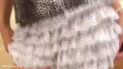 Brunette ladyboy in black bra plays with her hairy cock on the couch