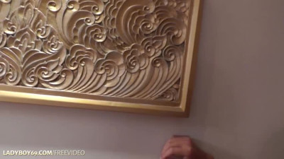 Short-haired ladyboy in black dress enjoys solo masturbation in bed